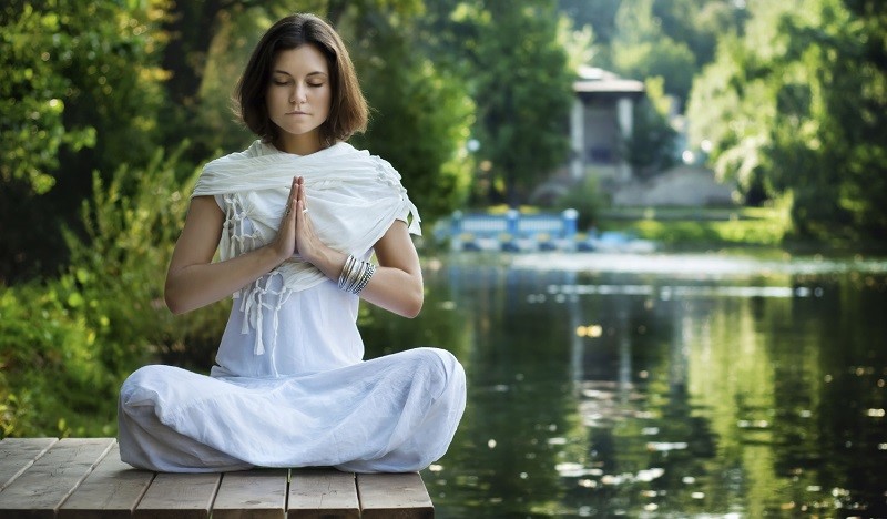 woman-meditating-by-lake-.jpg