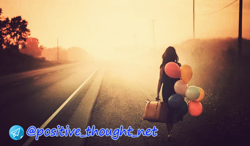 woman-walking-along-the-road-with-suitcase-and-balloons.jpg